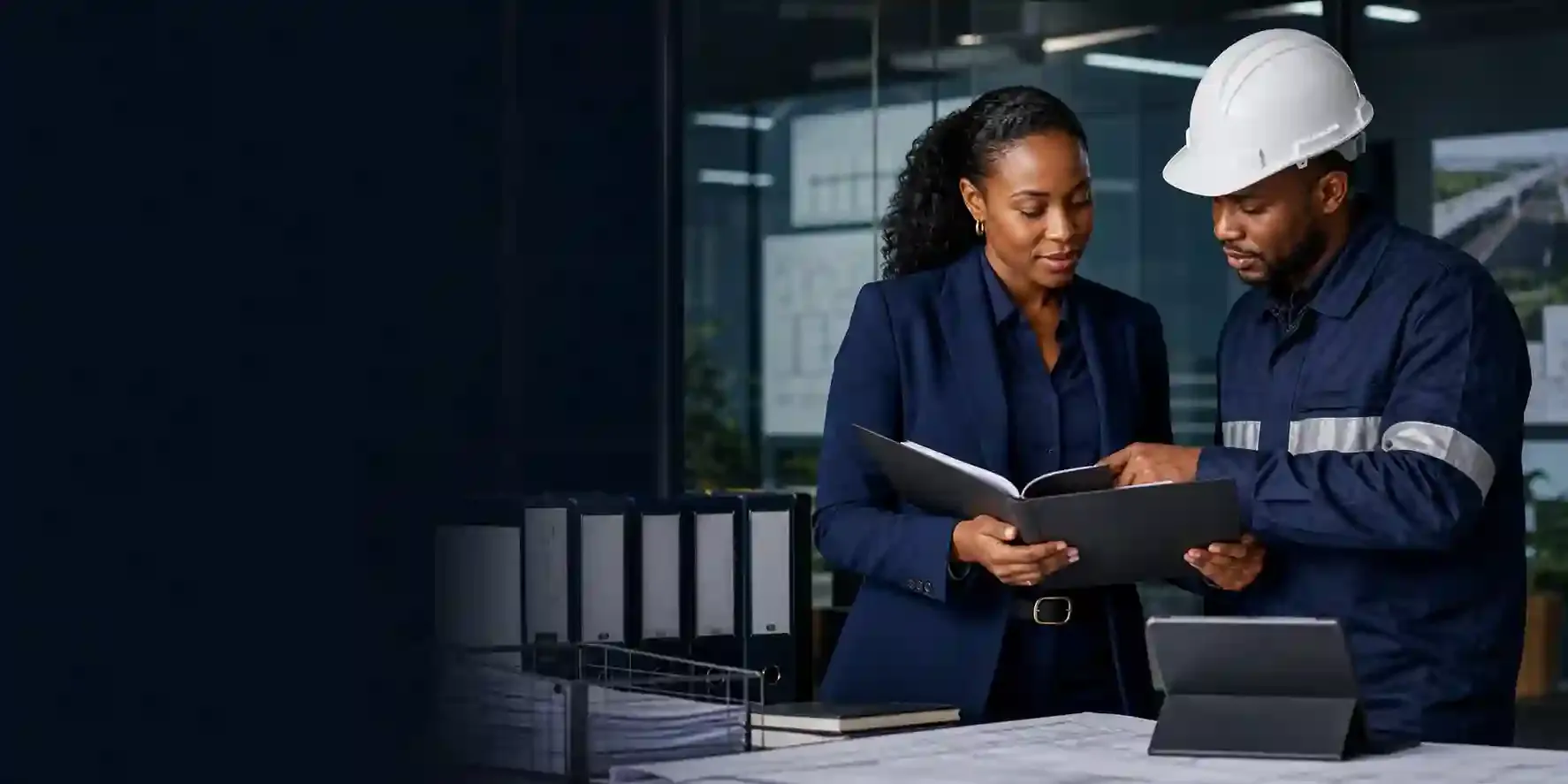 Compliance professional and project manager reviewing credentials and project documentation